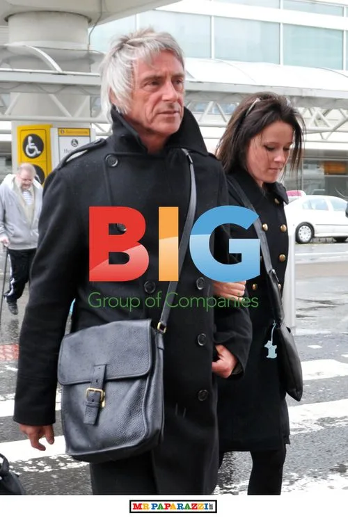 Paul Weller and girlfriend at Glasgow airport