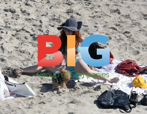 Phoebe Price beachside with dog
