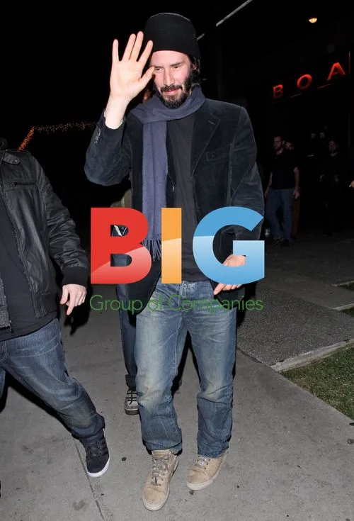 Keanu Reeves waves at fans outside Boa
