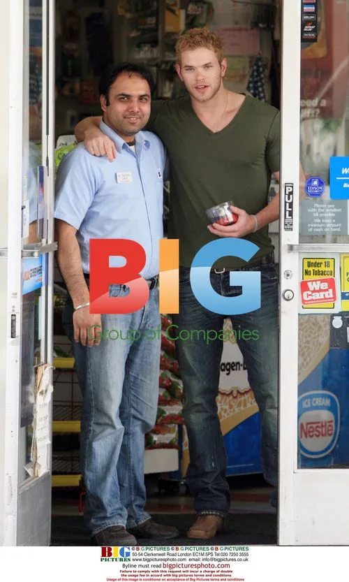 Kellan Lutz pumping gas and snacking