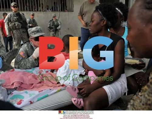 Cpt. Arnie Bailey checks on child in Haiti