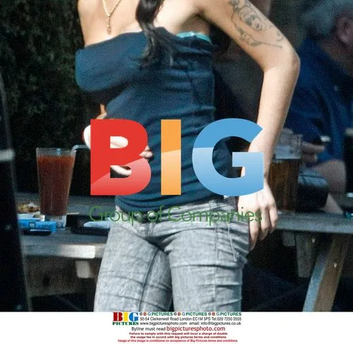 Amy Winehouse Interacts with Child at Pub