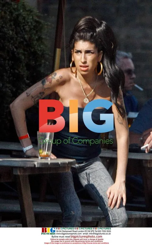 Amy Winehouse Interacts with Child at Pub