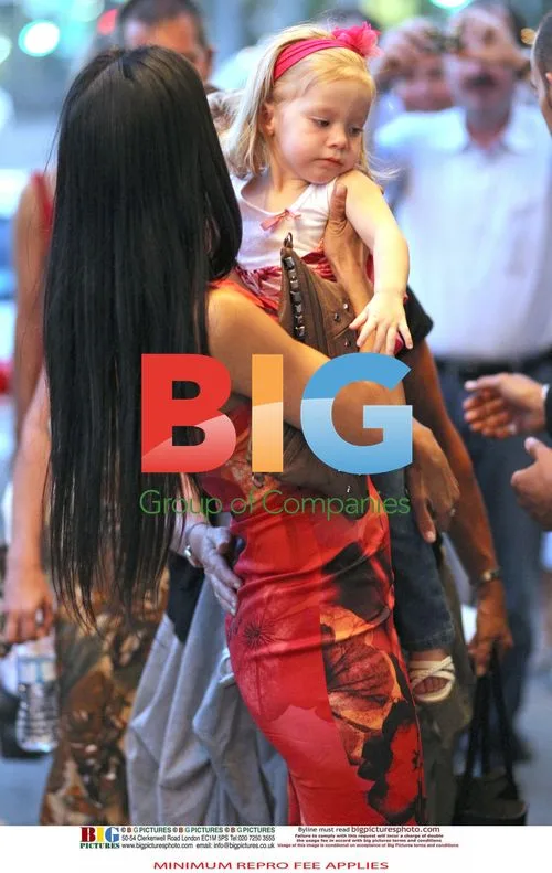 Nicole Scherzinger and Lewis Hamilton with a child