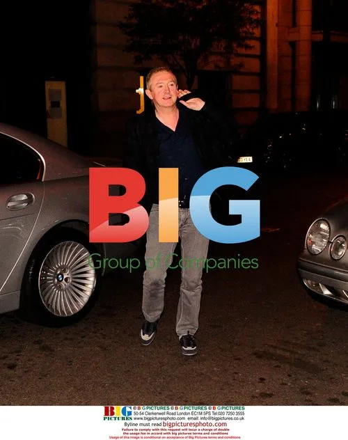 Louis Walsh Greeted by 'Celebrity Hugger'