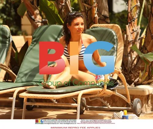 Roxanne Pallette Relaxes Poolside