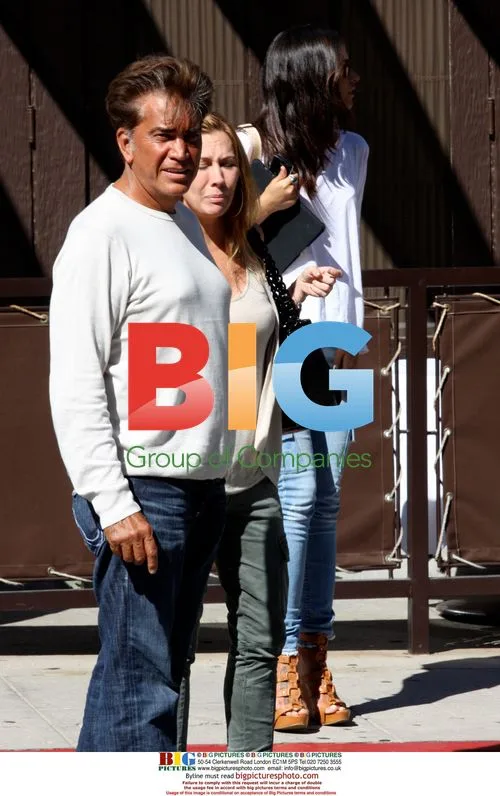 El Puma and Family Wait for Car in Beverly Hills