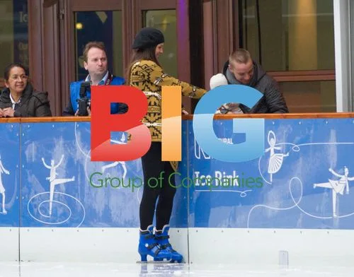 Danielle Lloyd and Jamie O'Hara ice skating with kid