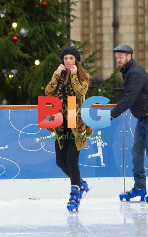 Danielle Lloyd and Jamie O'Hara ice skating with child