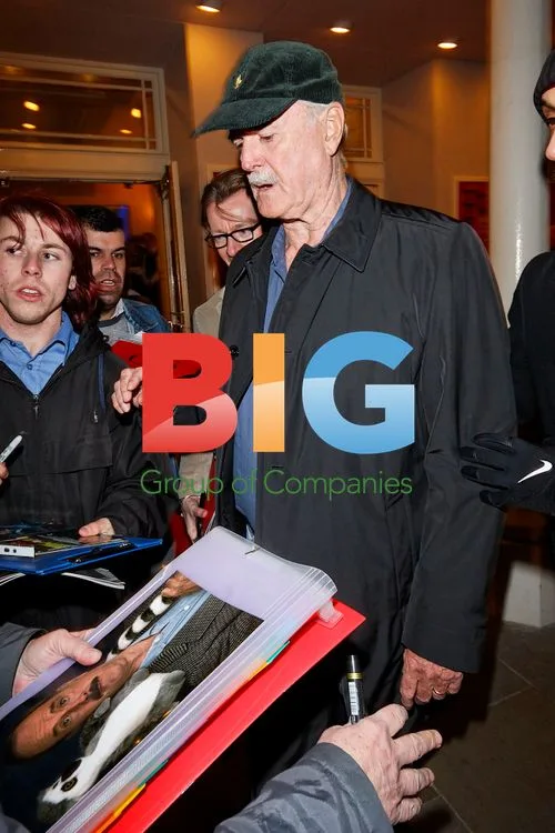 John Cleese Leaving in Police Car