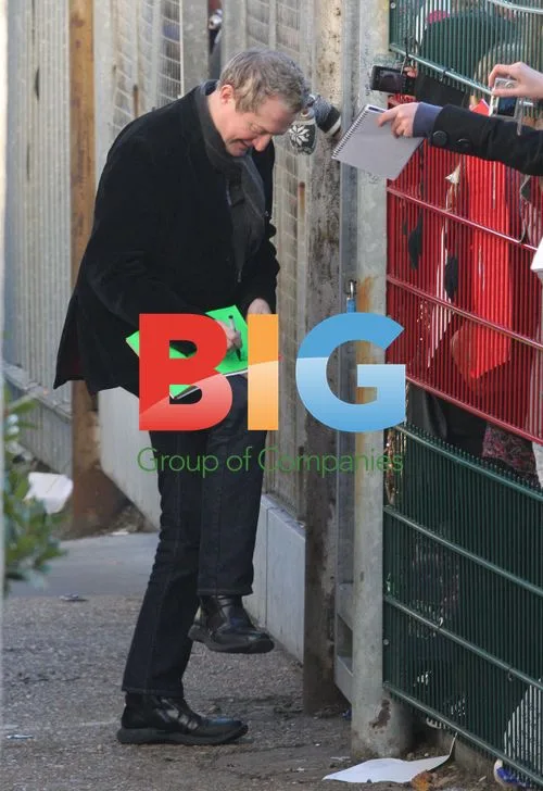 Louis Walsh signs autographs