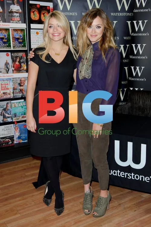 Holly Willoughby and Fearne Cotton sign book