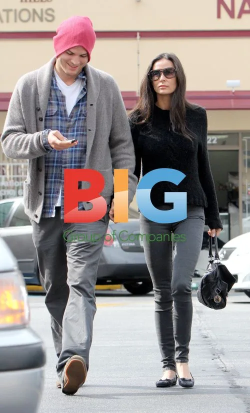 Ashton Kutcher opens car door for Demi Moore