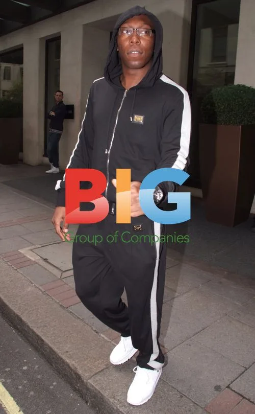 Dizzy Rascal carrying award in London