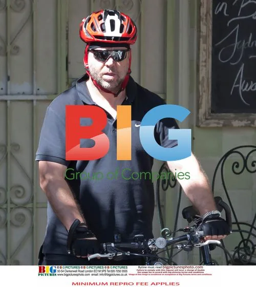 Russell Crowe Takes Cigarette Break, Bikes
