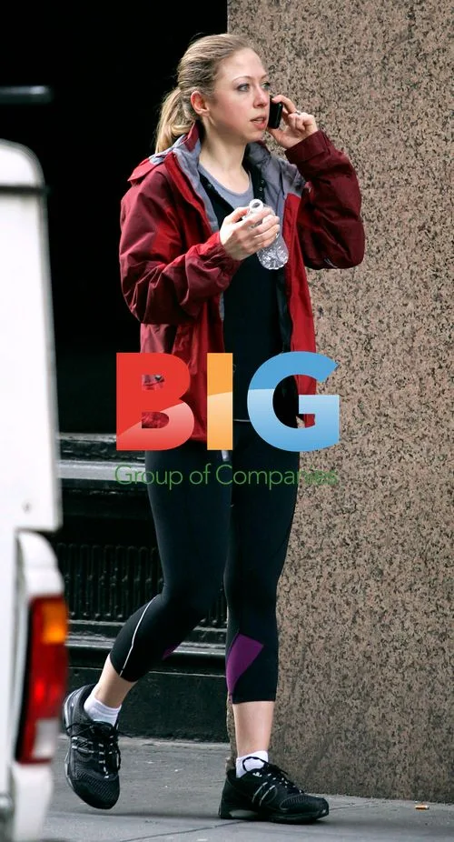 Chelsea Clinton walks and talks on phone in New York