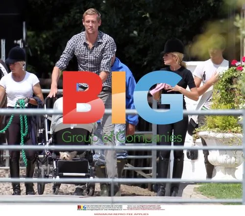 Abigail Clancy-Crouch, Peter Crouch, and daughter at stables