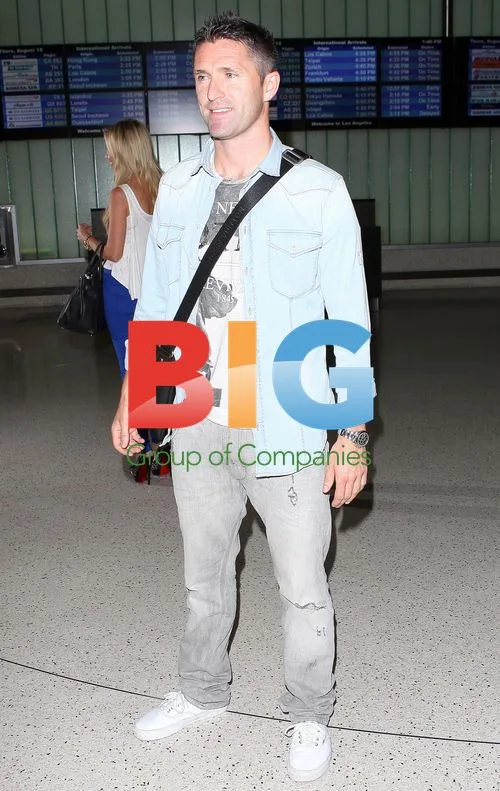 Robbie Keane and wife Claudine arrive at LAX