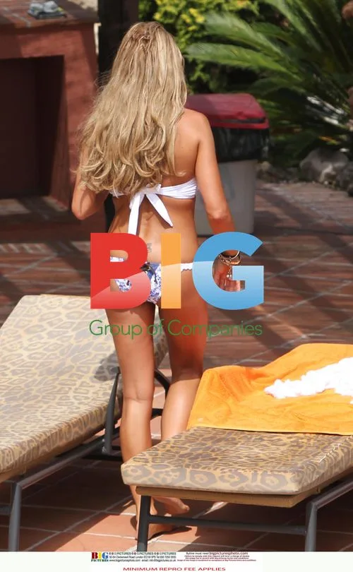 Katie Price Relaxes Poolside in Spain