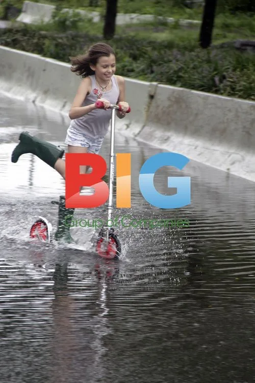Girl on scooter in flooded NYC street