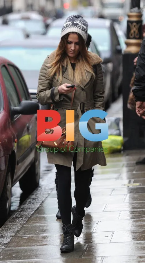 Caroline Flack walks in London rain