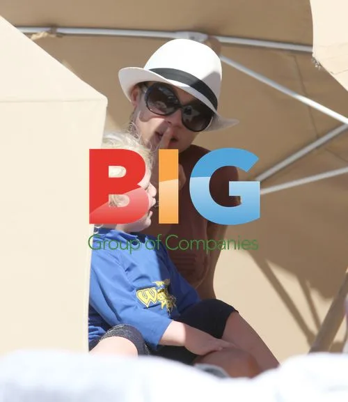 Sharlely Becker Plays with Sons at Beach