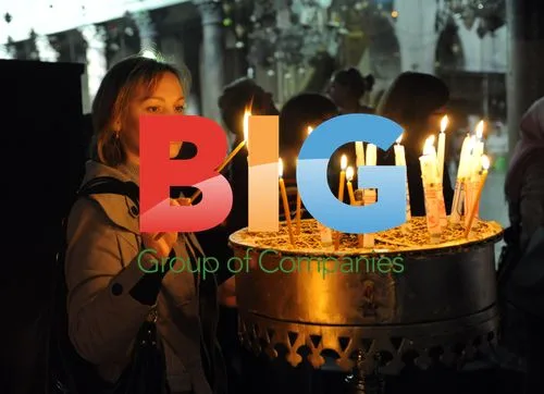 Christian tourist lights candle in Bethlehem church