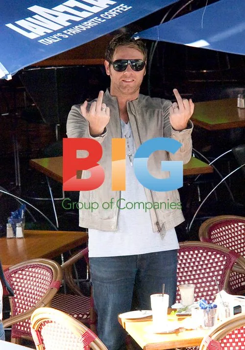 Brian McFadden gestures at photographer in Sydney