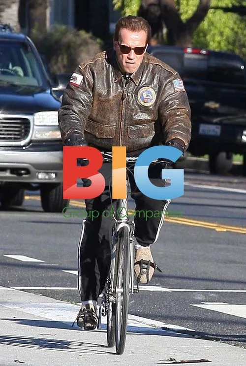 Arnold Schwarzenegger bikes with friend