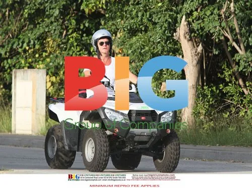 Simon Cowell and Mezhgan Hussainy on Quad Bikes