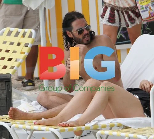 Russell Brand relaxes poolside in Miami