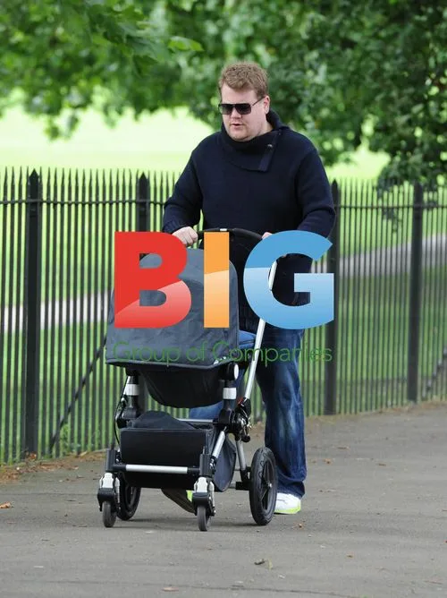 James Corden walking baby in London