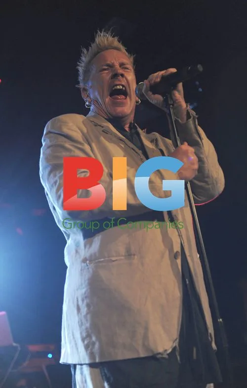 Johnny Rotten Performing with Drink on Stage