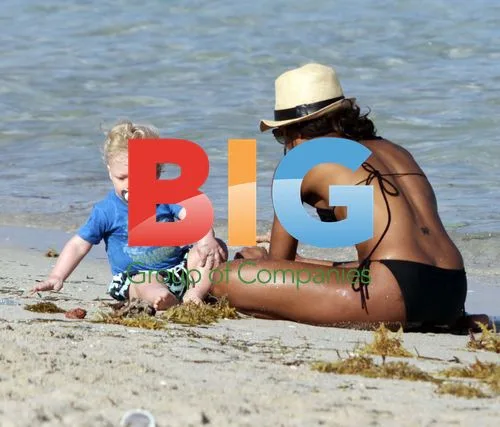 Amadeus Becker plays on the beach with nanny