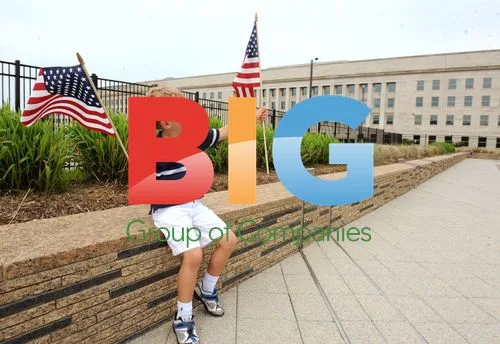 Boy holds American flags at Pentagon 9/11 memorial