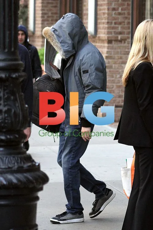 Sacha Baron Cohen hides face from cameras