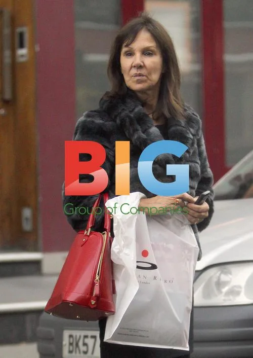 Arlene Phillips waits for car outside London hotel