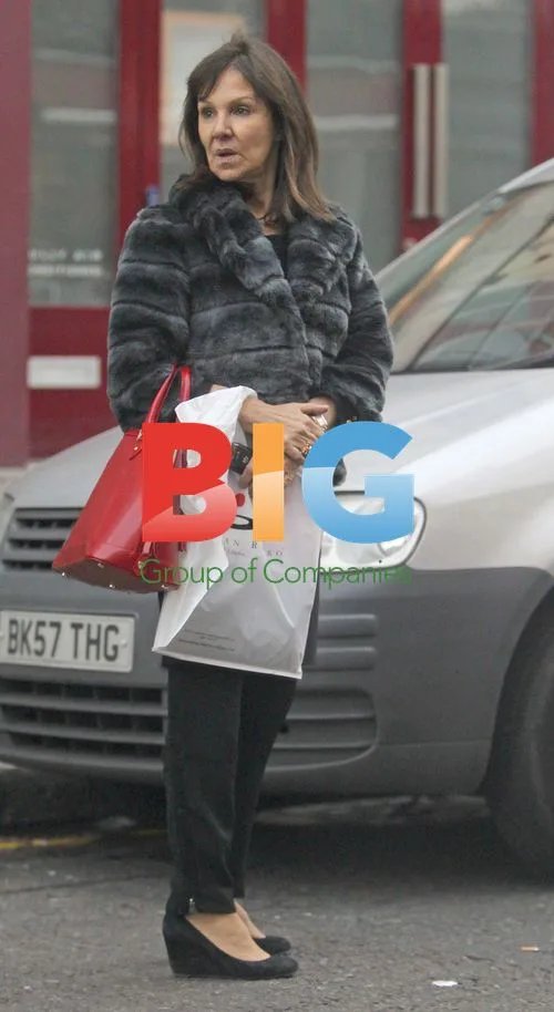 Arlene Phillips Waiting for Car Outside Hotel