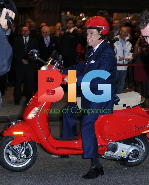 Regis Philbin falls off Vespa on set