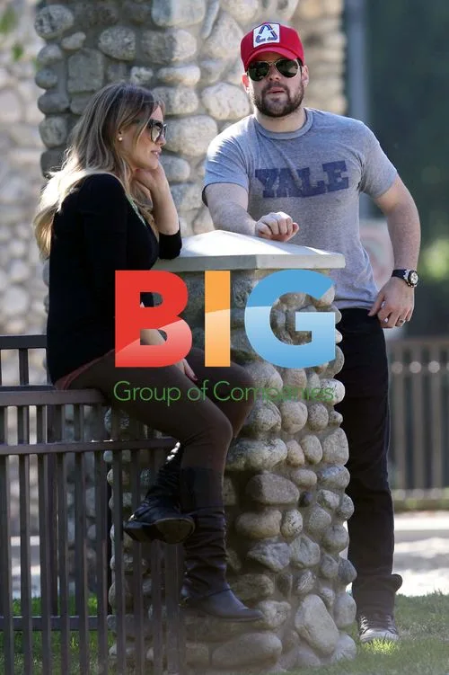Hilary Duff and Mike Comrie play with dog