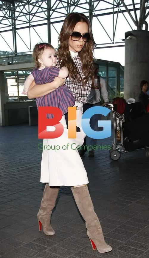 Victoria Beckham Carries Baby Harper at LAX