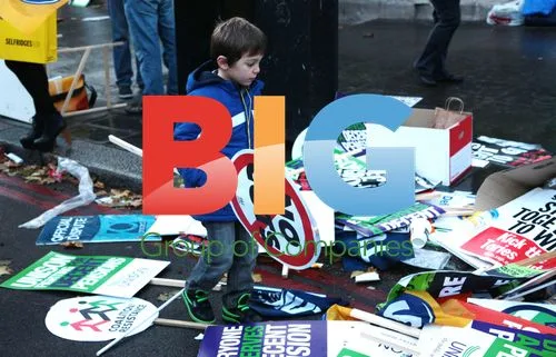 Boy walks among strike banners
