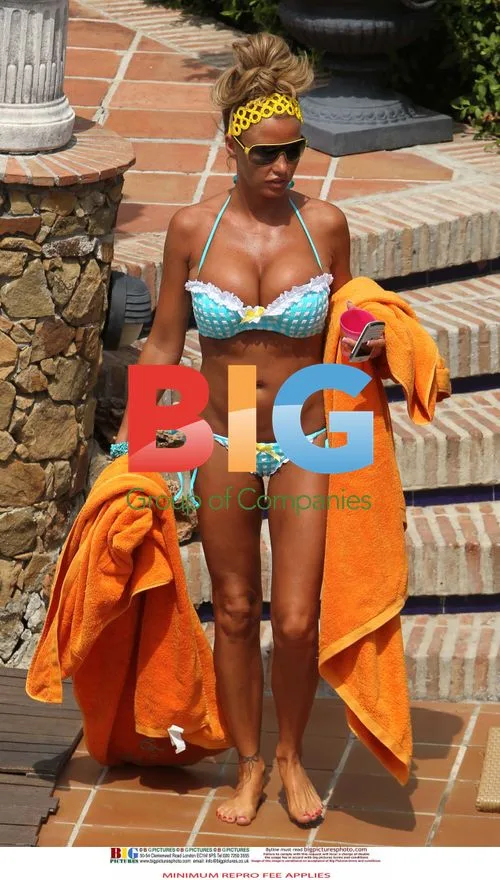 Katie Price Relaxes by Pool in Spain