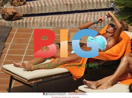 Katie Price Relaxes Poolside in Spain