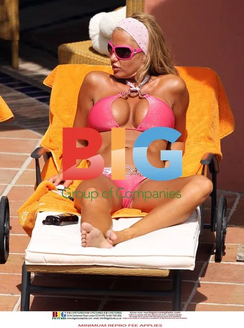 Katie Price Relaxing Pool Side in Spain