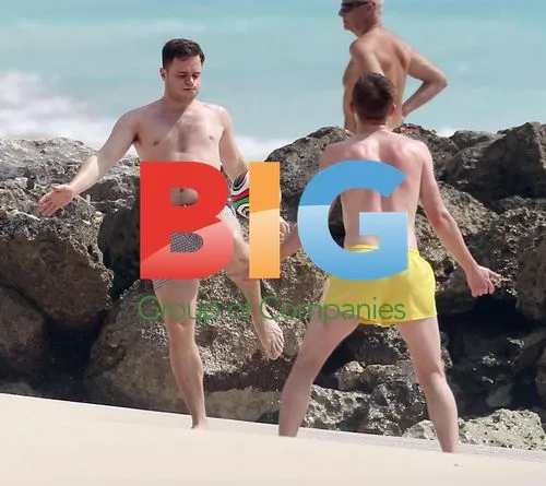 Olly Murs playing football on beach