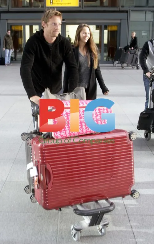 F1 Driver Jenson Button Arrives at Heathrow