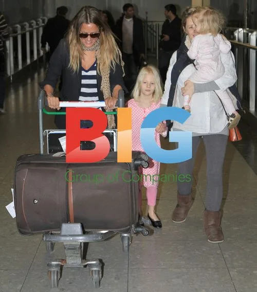 Caroline Flack Arrives at Heathrow with Family
