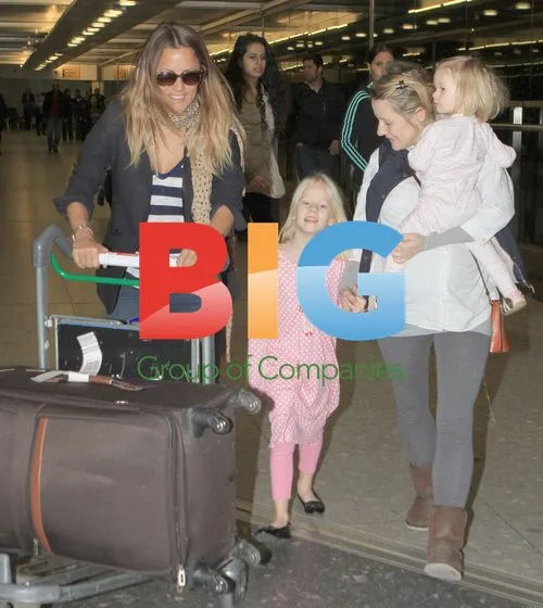 Caroline Flack returns from India with family