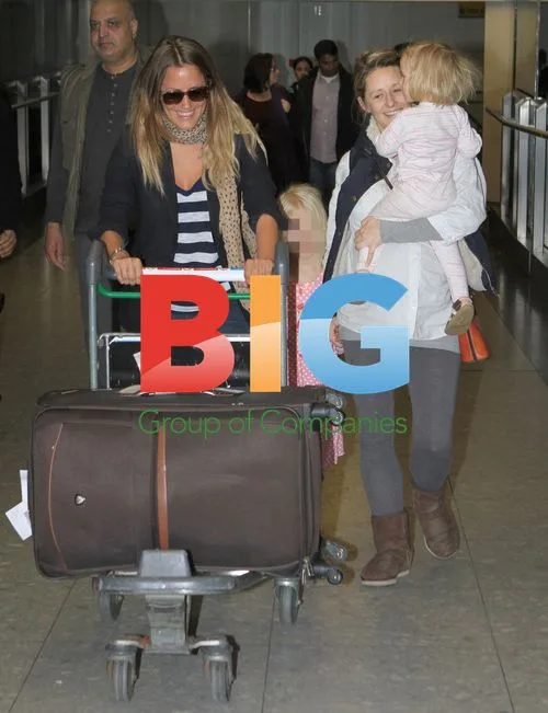 Caroline Flack returns from holiday